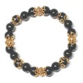 Onyx Armband in schwarz mit goldenen Perlkappen und Goldperlen